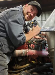 Meet your Mechanic!
Liam is our newest journeyman! He is a big cummins buff and enjoys digging into the ISX’s in the shop or a 5.9 in his down time. Liams black and white take on pulling wrenches means he goes through lots of our safeties, so everything is by the book. When not at the shop he is quick to lend a hand, grab a fishing rod or head out skeet shooting. You may see him around town walking his two large dogs. Liam likes being home every night and the focus that a small business brings to family means Prairie Diesel is the place for him.
